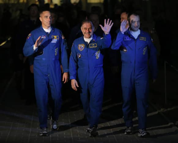 Russian Cosmonauts Alexander Misurkin and Pavel Vinogradov, US astronaut Christopher Cassidy, crew members of the mission to the International Space Station, ISS, walk to a bus from a hotel prior to the launch of their Soyuz-FG rocket at the Russian leased Baikonur cosmodrome, Kazakhstan.