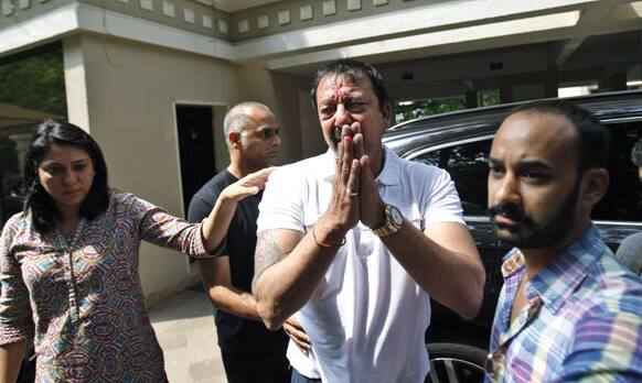 Bollywood actor Sanjay Dutt gestures to the media after he broke down during a press conference as his sister Priya Dutt stands next to him at his residence in Mumbai.