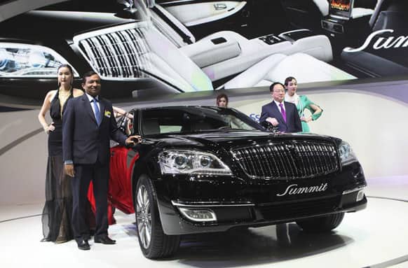 Pawan Kumar Goenka, president of Mahindra & Mahindra LMT, pose with a Ssangyong`s new model,