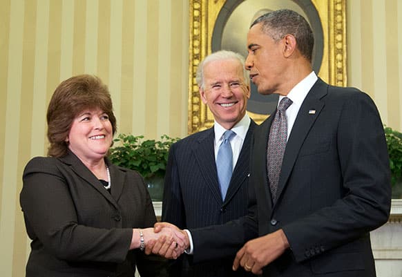 President Barack Obama shakes hands with the new director of the U.S. Secret Service Director Julia Pierson after she was sworn-in by Vice President Joe Biden.