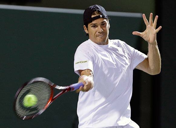 Tommy Hass of Germany, returns a shot from Gilles Simon of France, during the Sony Open tennis tournament.