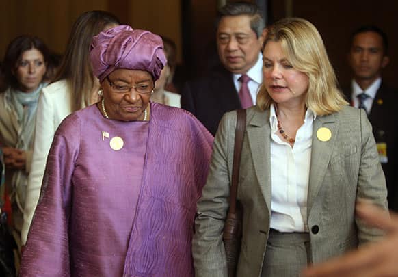 Leberian President Ellen Johnson Sirleaf, left, walks with Justine Greening, British Secretary of State for International Development, right, during the UN high level panel meeting on post-2015 development in Nusa Dua, Bali, Indonesia.