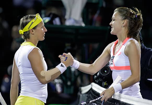 Kirsten Flipkens, of Belgium, left, congratulates Agnieszka Radwanska, of Poland, after their match at the Sony Ericsson Open tennis tournament in Key Biscayne, Fla.