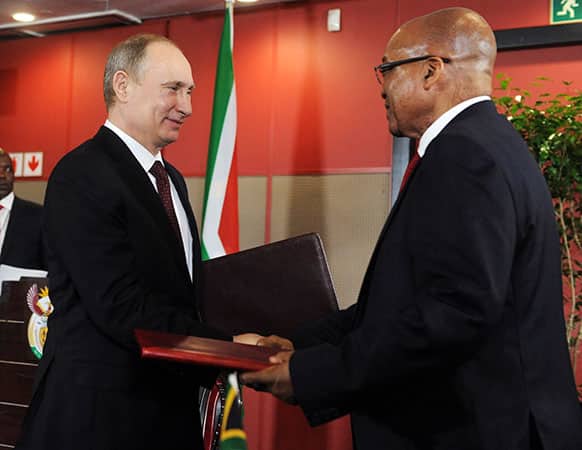 Russian President Vladimir Putin and South African President Jacob Zuma exchange documents after signing the Declaration of State Partnership between South Africa and Russia at the BRICS 2013 Summit in Durban, South Africa.