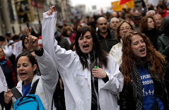Protesters shout slogans during a demonstration against regional government-imposed austerity plans to restructure and part-privatize the health care sector in Madrid, Spain.