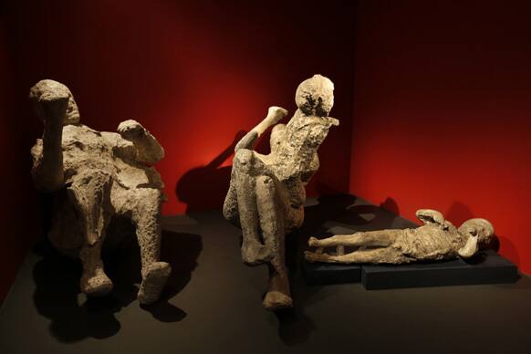 Casts of a family of two adults and two children who died together in an alcove in Pompeii, made by filling plaster in the void left by their bodies, are seen during a photo call for the upcoming exhibition entitled `Life and death Pompeii and Herculaneum`, at the British Museum.
