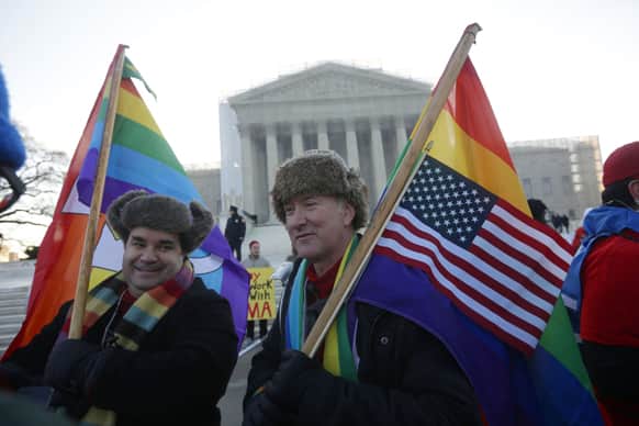 Marcus and Daniel German-Dominguez stand outside the Supreme Court in Washington, before the court`s hearing on California’s voter approved ban on same-sex marriage.
