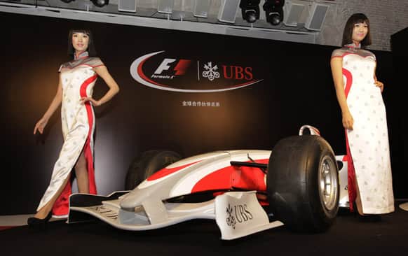 Models show new Grid Girl uniform ahead of the Chinese Formula One Grand Prix on Tuesday March 26, 2013 in Shanghai. This year marks the 10th anniversary of China`s F1 which will take place on April 14 at the Shanghai International Circuit.