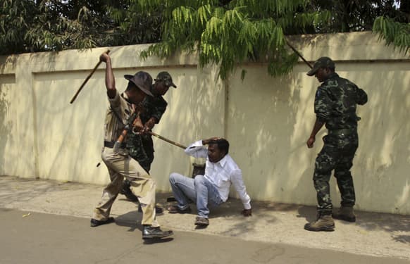 Policemen beat an opposition activist during a protest outside the Orissa state chief minister’s office in Bhubaneswar.