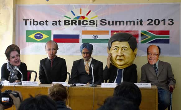Exiled Tibetans wearing masks of leaders of BRICS nations stage a mock presentation in Dharamsala, India.