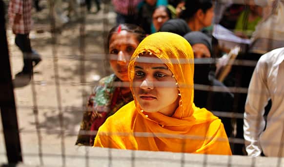 An unemployed Indian woman stands in a queue to register herself at the Employment Exchange Office in Allahabad.