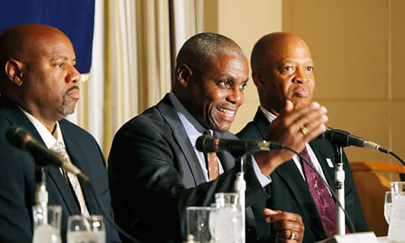 US Olympian Carl Lewis, center, speaks as fellow Olympians Mike Powell, left, and Willie Banks listen during a press conference in Tokyo.