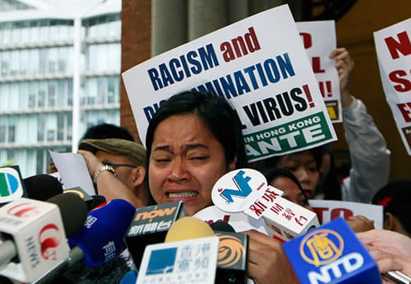 Sringatin, a member of a domestic workers union, cries outside the Court of Final Appeal in Hong Kong.