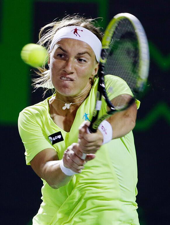 Svetlana Kuznetsova, of Russia, returns a shot from Ana Ivanovic, of Serbia, during the Sony Open tennis tournament.