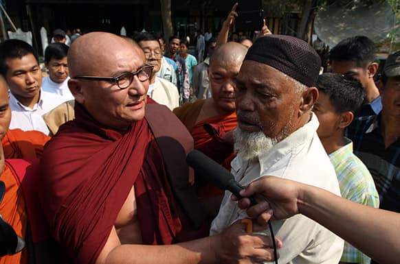 A Myanmar Buddhist monk comforts Muslim refugees, during ethnic unrest between Buddhists and Muslims, as they visit a rescue camp along with Vijay Nambiar, unseen, U.N. Secretary General Ban Ki-moon’s special adviser on Myanmar, in Meikhtila, Mandalay division, Yangon.