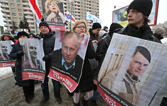 Belarusian opposition protesters carry portraits of various political prisoners during a rally in Minsk, Belarus.