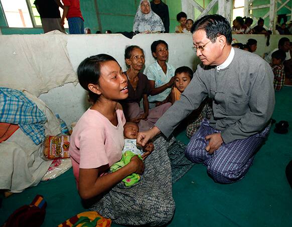 Aung Min, a minister of the Myanmar president`s office, comforts Muslim refugees while visiting a shelter with Vijay Nambiar, the UN secretary-general`s special adviser on Myanmar, unseen, following ethnic unrest between Buddhists and Muslims, in Meikhtila, Mandalay division, Yangon.