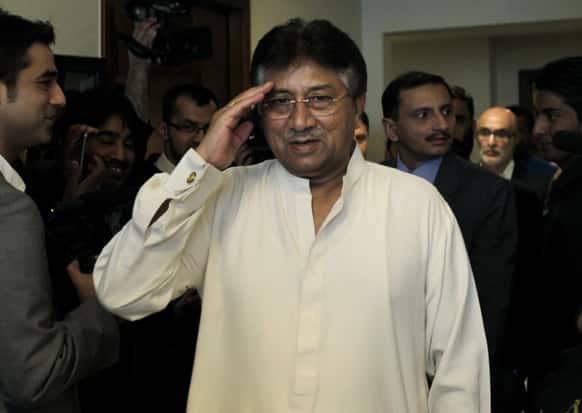 Former Pakistani President Pervez Musharraf salutes journalists as he arrives in his office for a press briefing before leaving to Karachi in Dubai, United Arab Emirates.