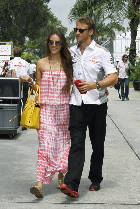 McLaren driver Jenson Button of Britain and his girlfriend Jessica Michibata arrive at the Malaysian Formula One Grand Prix in Sepang, Malaysia.