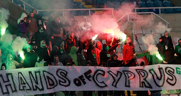 Cypriot soccer fans with an anti-bailout protest banner during the group E 2014 World Cup qualifying soccer match between Cyprus and Switzerland at GSP stadium in Nicosia, Cyprus.