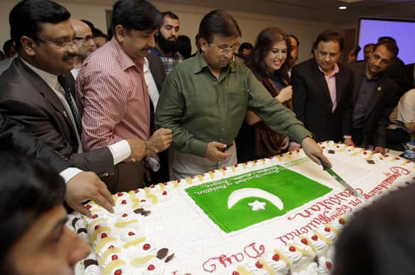 Former Pakistani President Pervez Musharraf cuts a cake during a ceremony to celebrate Pakistan National Day ahead od his trip to Karachi, in Dubai, United Arab Emirates.