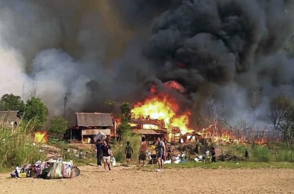 Karen refugees flee the Ban Mae Surin refugee camp as the fire broke out at their thatch huts in Mae Hong Son province, northern Thailand. At least 32 Myanmar refugees died in a raging fire at this camp which house about 3,300 people.