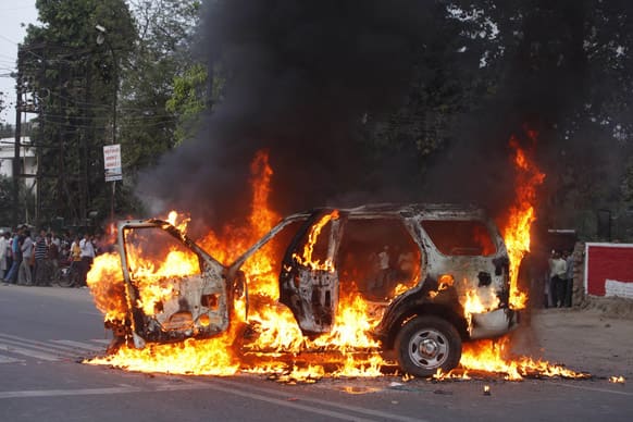 A vehicle stands in flames after it was set on fire by lawyers in Allahabad. The car had earlier hit a lawyer and others reacted to it, according to reports.
