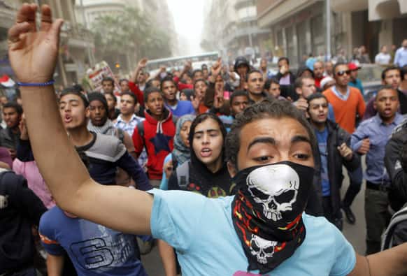 Egyptians shout anti-Muslim Brotherhood slogans during a march to the Brotherhood headquarters in Cairo, Egypt.