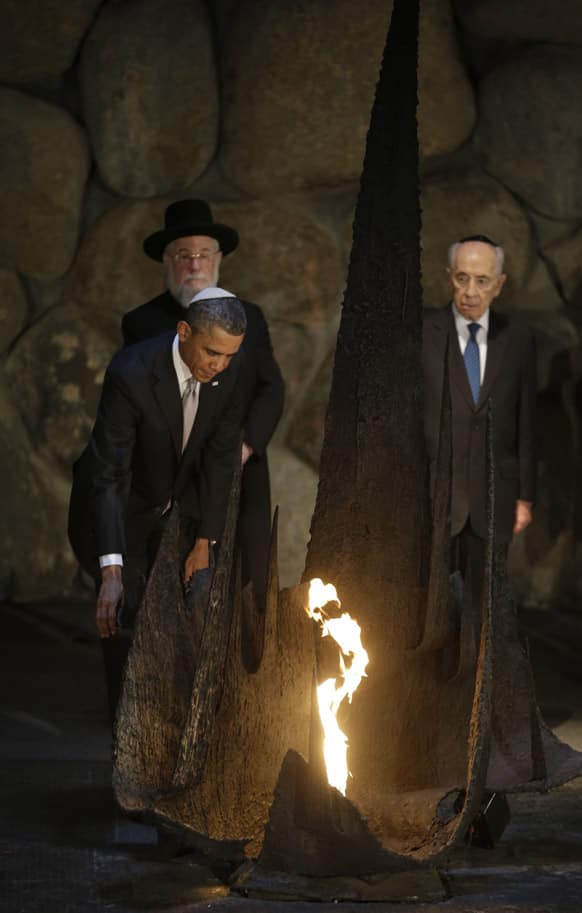 US President Barack Obama reignites the flame during his visit to the the Hall of Remembrance at the Vad Vashem Holocaust Memorial in Jerusalem, Israel.