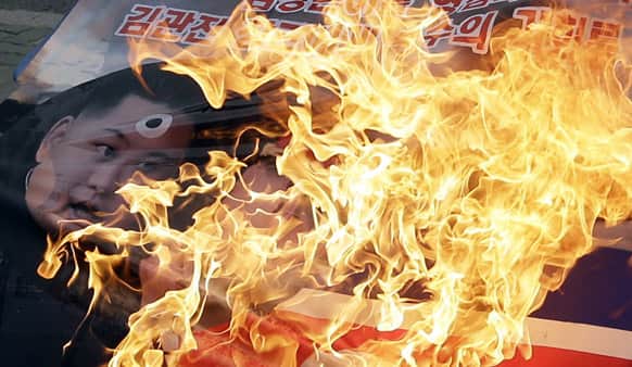 South Korean protesters burn a picture of North Korean leader Kim Jong Un with national flag during an anti-North Korea and pro-South Korea rally near the National Assembly in Seoul.