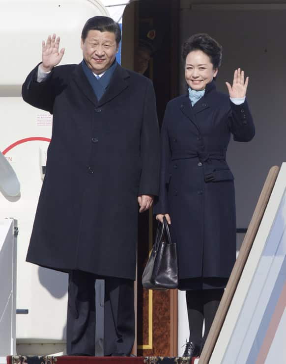 Chinese President Xi Jinping and his wife Peng Liyuan wave upon their arrival to the government airport Vnukovo II, outside Moscow, Russia.