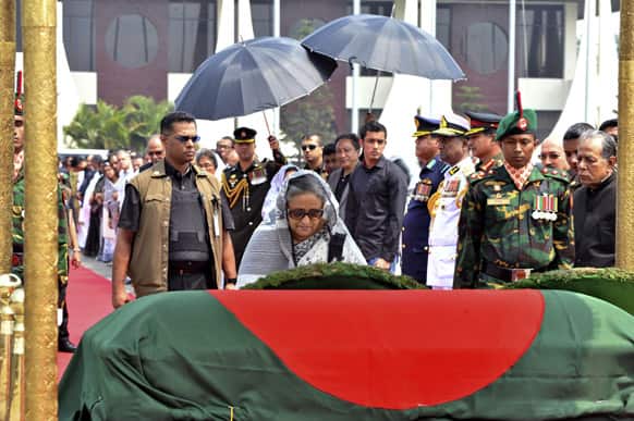 Bangladesh`s Prime Minister Sheikh Hasina pays her respects after the body of President Zillur Rahman arrived at the airport in Dhaka. Rahman died Wednesday at a hospital in Singapore. He was 84.