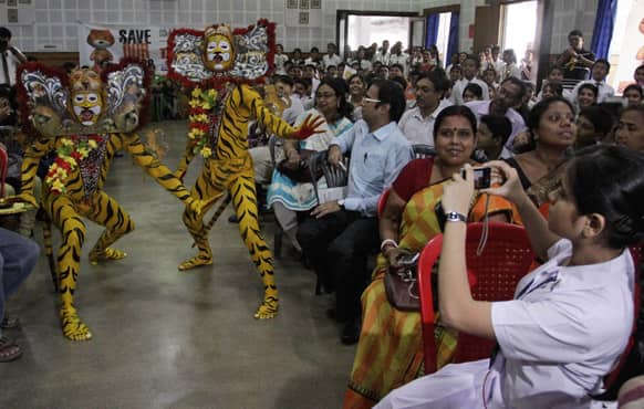 Traditional tiger dancers from Orissa state perform during a Save Our Tigers awareness campaign in Kolkata.