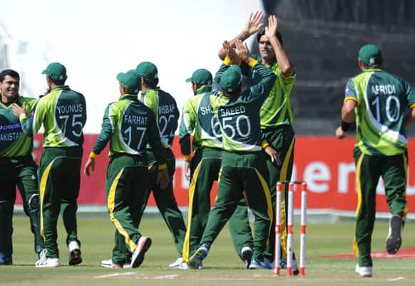 The Pakistani cricket team celebrate the wicket of South Africa`s Hashim Amla, unseen, during their One Day International Cricket match in Durban.