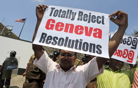 A Sri Lankan government supporter holds a placard during a protest outside the US Embassy against a United States-sponsored draft resolution discussed at the United Nations Human Rights Council in Geneva.