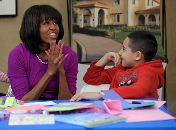 First lady Michelle Obama talks with Jorge Ortiz during her visit to the Fisher House, located at Walter Reed National Military Medical Center in Bethesda, Md., for a pre-Easter celebration with military families and children.