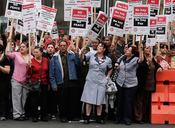 Culinary Union workers demonstrate along Las Vegas Boulevard outside the Cosmopolitan Hotel and Casino while protesting their contract negotiations with Deutsche Bank.