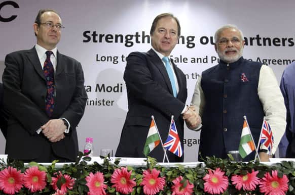British Minister of State for Foreign and Commonwealth Office Hugo Swire shakes hands with India’s Gujarat state chief minister Narendra Modi at Gandhinagar as British High Commissioner to India James Bevan, left, watches at Gandhinagar in Gujarat.