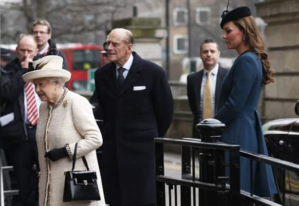 Britain`s Kate, Duchess of Cambridge, right, accompanies Queen Elizabeth II and Prince Philip as they arrive at Baker Street underground station in London for a visit to mark the 150th anniversary of the London Underground.