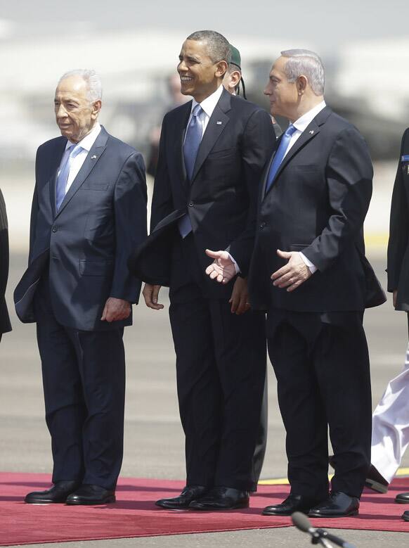 President Barack Obama is greeted by Israeli President Shimon Perez and Israeli Prime Minister Benjamin Netanyahu upon his arrival ceremony at Ben Gurion International Airport in Tel Aviv, Israel.