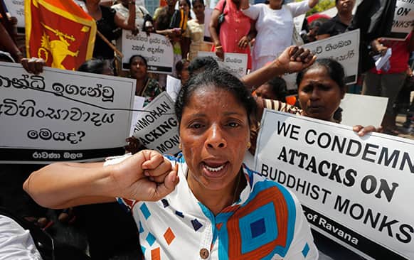 A Sri Lankan woman of a civic group called the Ravana Balaya, or Ravana Force, shouts slogans during a protest outside the Indian High Commission in Colombo.