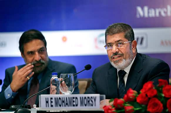 Egyptian President Mohammed Morsi, right, addresses Indian industry leaders, as Indian Minister for Commerce and Industry Anand Sharma listens at a business meeting in New Delhi.