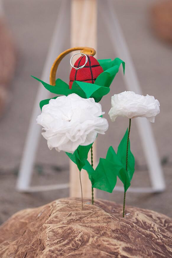 A fake grenade depicted as a flower, sprouting from an imitation gravesite is pictured in front of the US Embassy during a protest by Amnesty International human rights activists, demonstrating in favor of an internationally binding agreement that would regulate the global arms trade, in Mexico.