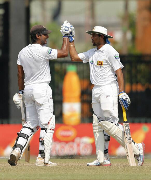 Sri Lankan batsmen Kumar Sangakkara and Tillakaratne Dilshan cheer a moment during the fourth day of the second test cricket match between Sri Lanka and Bangladesh in Colombo.