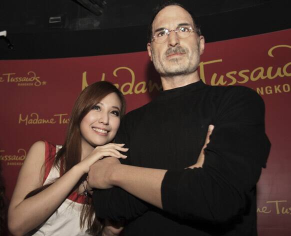 A Thai visitor poses with a wax figure of Steve Jobs at the Madame Tussauds wax museum in Bangkok, Thailand.