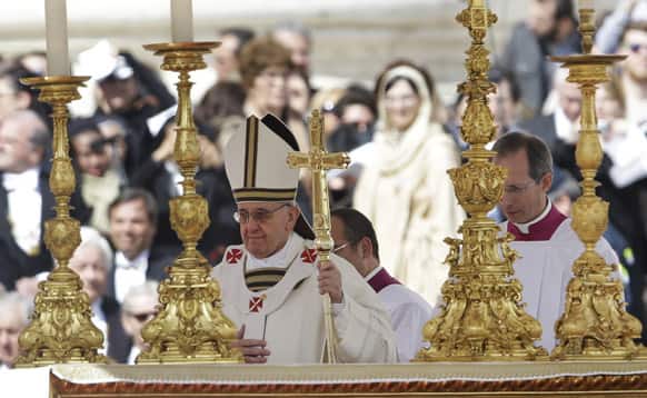 Pope Francis walks past the alter in front of St. Peter`s Basilica in St. Peter`s Square following his inauguration Mass at the Vatican.