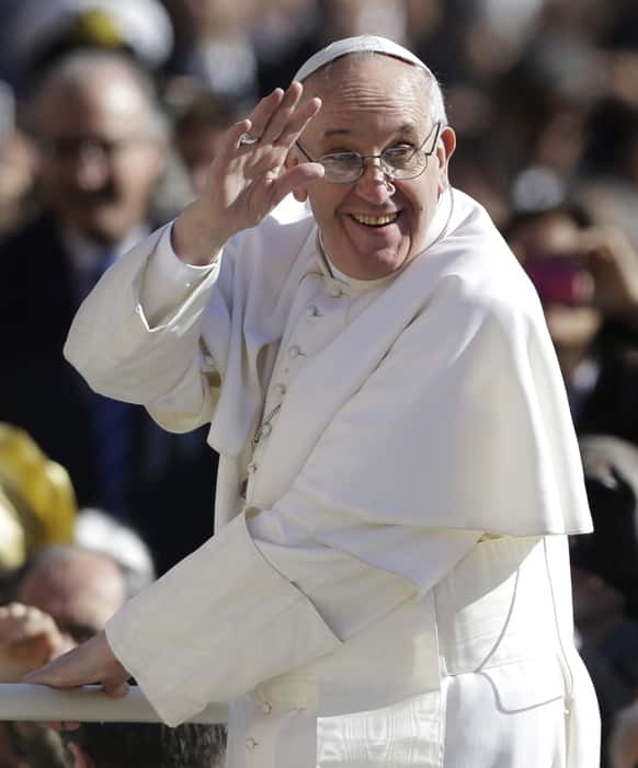 Pope Francis waves to crowds as he arrives to his inauguration Mass in St. Peter`s Square at the Vatican.