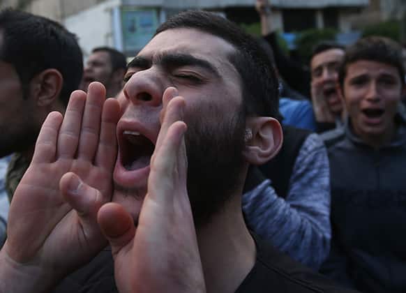 A Lebanese Sunni protester chants religious slogans, during a protest after two Sunni Muslim sheikhs at dar al-Fatwa, Lebanon`s highest Sunni Authority, were attacked by Shiite men late Sunday, in Beirut, Lebanon.