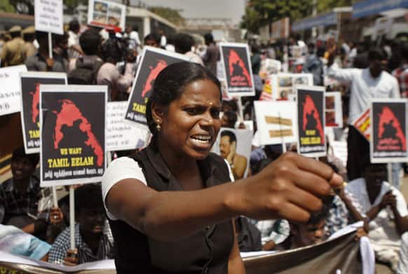 Indian Tamil activists protesting against Sri Lanka’s alleged war-time abuses hold placards demanding
