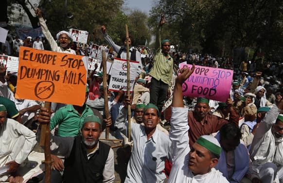 Farmers shout slogans against the government as they stage a protest near the Indian Parliament in New Delhi.